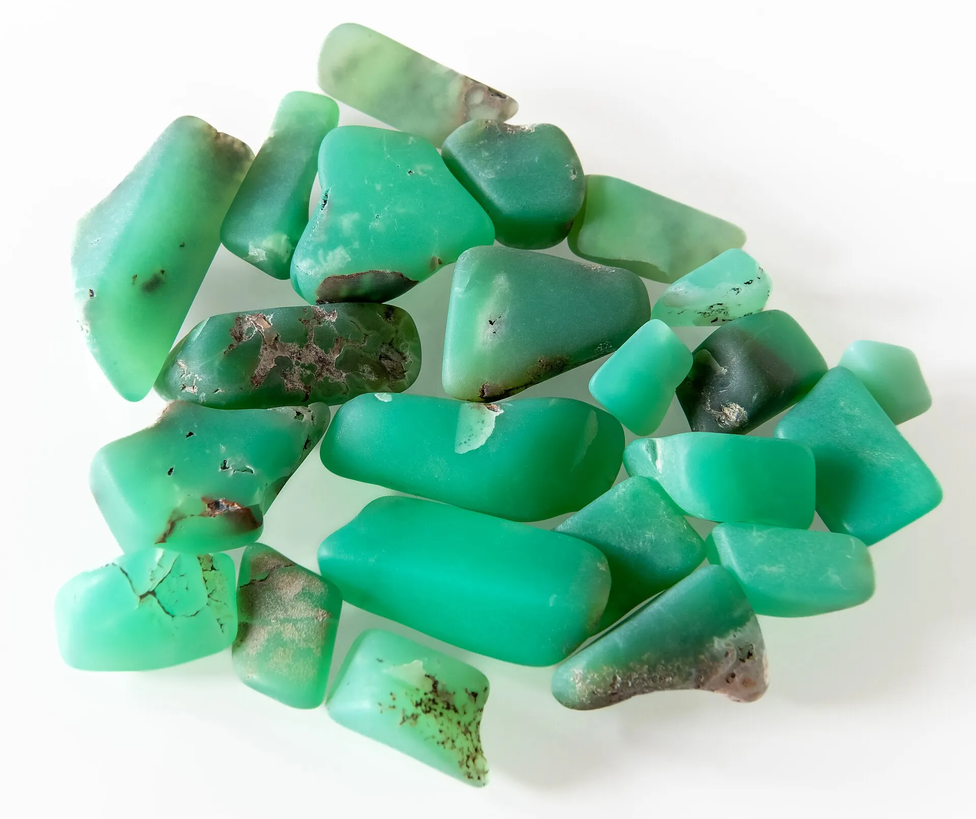 Green chrysoprase stones with a semi-polished, matte surface